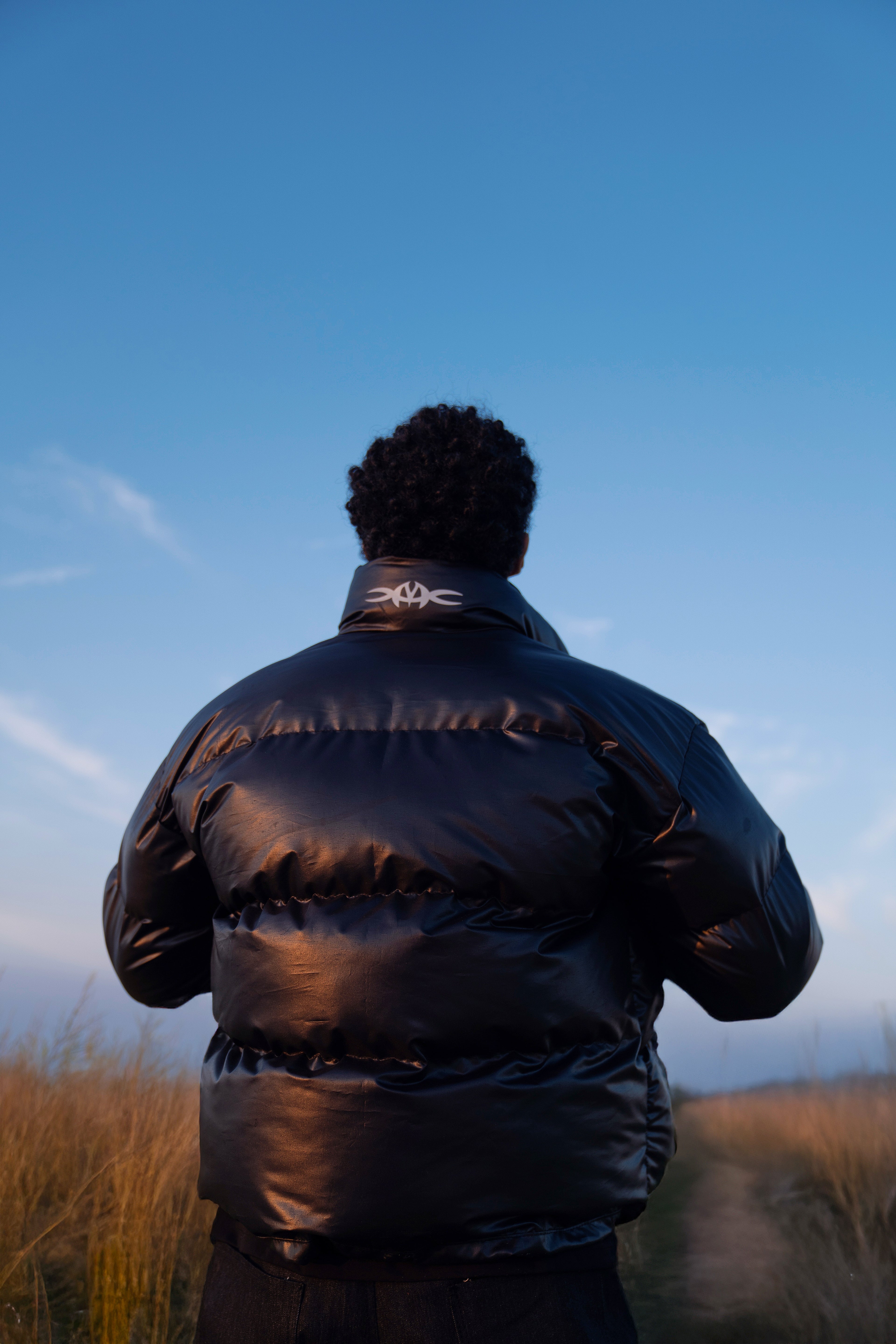 Leather effect puffer jacket in black